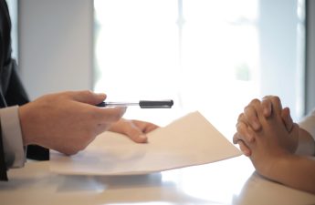 property manager giving lease agreement to tenant to sign